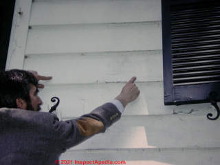 Daniel Friedman pointing out a paint failure and water leaks out of clapboard siding on a Poughkeepsie home ca 1980 (C) Daniel Friedman at InspectApedia.com