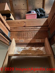 Unsafe top step on attic pull-down stairs (C) InspectApedia.com Kevin