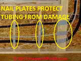 Steel plates protect tubing run in walls © D Friedman at InspectApedia.com 