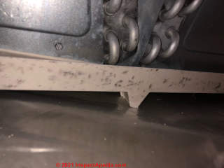 Black marks on plastic A/C condensate drip tray don't look like mold (C) Inspectapedia.com capelli