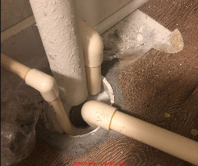 Air conditioning condensate drains over an open sewer pipe or drain - unsafe? (C) Inspectapedia.com MD