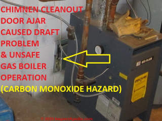 Chimney cleanout doorleft ajar caused poor draft and unsafe gas burner operation - carbon monoxide hazard (C) Daniel Friedman at InspectApedia.com