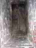 Photograph of  this un-lined single wythe brick chimney flue interior at its bottom