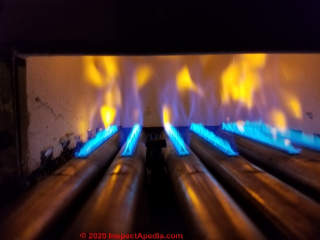 Yellow gas burner flame, improper gas boiler operation, draft & dirt & adjustment corrections needed (C) Daniel Friedman at InspectApedia.com