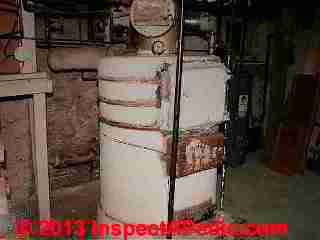 Hardcast asbestos on heating boiler © D Friedman at InspectApedia.com 