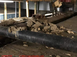 Possible asbestos-containing fireproofing spray falling off of a ceiling (C) InspectApedia.com Lowenstein H