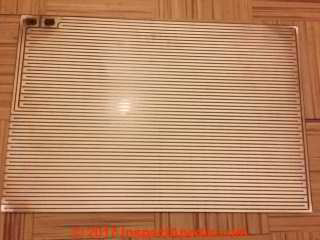 Radiant heat glass panel - from a heater that may have used asbestos (C) InspectApedia.com - Marie