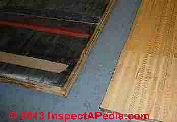 Fiberboard insulation used under bowling alley lane (C) InspectAPedia - AC