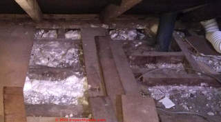 white powdery attic insulation (C) InspectApedia.com Vanessa