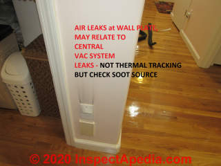 Soot staining above central vac fitting - may relate to air leaks in vac system but also find the soot source - safety concern (C) InspectApedia.com Kahn