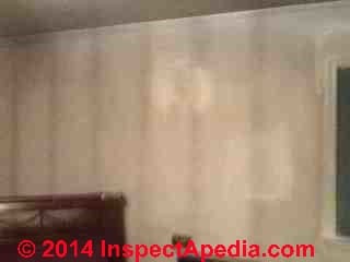 Vertical black stripe stains on walls are most likely thermal tracking or ghosting (C) InspectApedia 