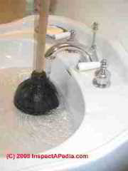 Toilet plunger clearing a sink drain (C) Daniel Friedman