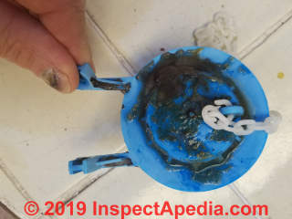 Dirty leaky toilet flapper valve (C) Daniel Friedman at InspectApedia.com