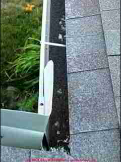 Photograph of Photograph of roof shingle mineral granules in the gutter due to hail damage