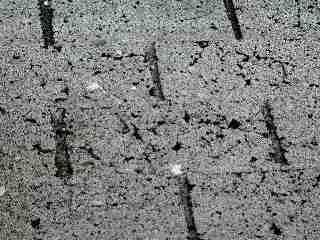 Photograph of worn fragile roof shingles that should not be walked-on