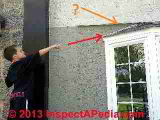 Tanner Daniel Gilligan points out a subsitution for roof-wall flashing over a bay window: the installer tried a wavy line of white caulk aghainst the gray stuco exterior. (C) Daniel Friedman Tanner Gilligan 2013