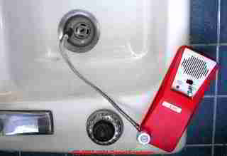 Photo of a TIF 8800 combustible gas analyzer being used to check a kitchen sink drain for sewer gas leaks
