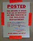 Photograph of a health department sign placed on a moldy apartment that was unsafe to enter.