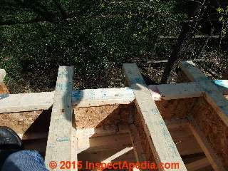 Blocking details at I-Joists over the wall top - these I-joists support the roof © Daniel Friedman at InspectApedia.com