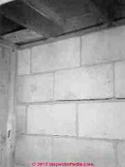Horizontal crack high in masonry block wall © Daniel Friedman at InspectApedia.com