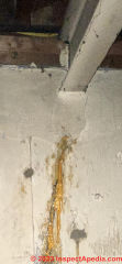 Leaking crack in concrete foundation wall below beam (C) InspectApedia.com Brandi