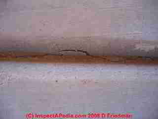 Photograph of a cracked concrete slab, cracks at a control joint
