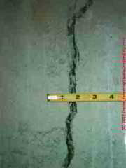 Photograph of settlement cracks in a concrete foundation wall © Daniel Friedman at InspectApedia.com