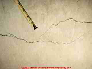 Photograph of shrinkage cracks in poured concrete © Daniel Friedman at InspectApedia.com