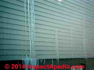 Ice forms at water exiting from vinyl siding due to roof ice dam leaks from above (C) Daniel Friedman