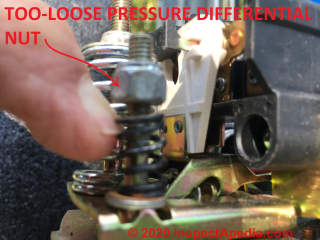 Smaller pressure differntial nut on a pressure control switch is completely loose (C) InspectApedia.com  Moby