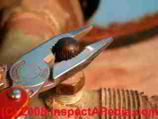 Photograph of using pliers to remove a valve stem cap