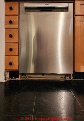 Dishwasher slid into place, ready for final leveling and then securing to the surrounding cabinet frame (C) Daniel Friedman at InspectApedia.com