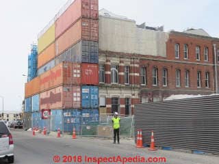 Shipping containers as emergency retaining wall to avoid building collapse - Christchurch NZ 2014 (C) Daniel Friedman at InspectApedia.com
