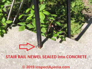 Exterior stair newel set into concrete with waterproof sealant to avoid frost cracking or rust damage (C) Daniel Friedman at InspectApedia.com