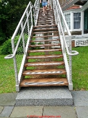 Modern stairway integrates Newel post, stair guards, and rails supported by the stair stringer (C) Daniel Friedman at InspectApedia.com