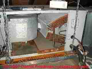 Photograph of attic air conditioning air handler, condensate drips on floor