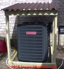 Roof over compressor/condenser unit can cause overheating (C) InspectApedia.com Rick