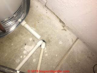 AC Condensate drains + water heater leak pan drain into floor drain (C) InspectApedia.com  Jeff