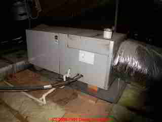 Photograph of attic air conditioning air handler, condensate drips on floor