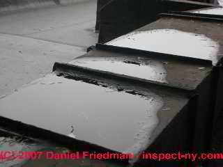Photograph of rooftop ducts leak water into fg lined duct