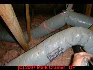 Photo of deteriorated fiberglass insulated gray covered Owens Corning gray flex duct (C) Daniel Friedman