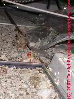 Photograph of commercial air conditioning system ceiling plenum with debris