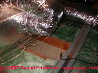 Photograph of  duct work in ground contact in a crawl space