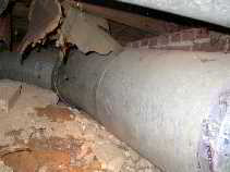 Photograph of  duct work in ground contact in a crawl space