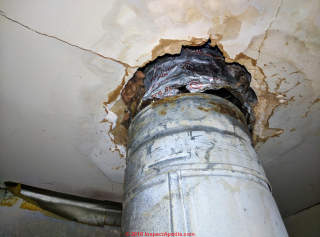 Disconnected joint in B-vent chimney + leaks - taped with foil tape - unsafe (C) InspectApedia.com Chris