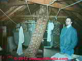 Photograph of a brick chimney cracked exterior, possibly due to heat.