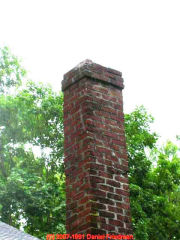 Photograph of a damaged unsafe brick chimney viewed from outside.