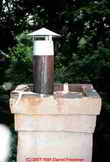 Photograph of a damaged masonry chimney.