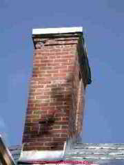 Photograph of a damaged masonry chimney.