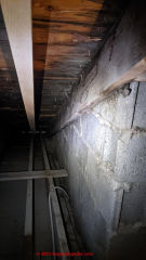 Stains in attic show long standing leaks at chimney (C) InspectApedia.com Tom